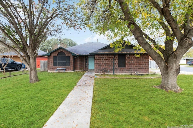 ranch-style house with brick siding and a front yard