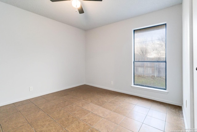 unfurnished room featuring a ceiling fan, baseboards, and tile patterned floors