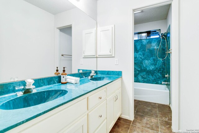 bathroom with a textured ceiling, double vanity, a sink, and bathing tub / shower combination