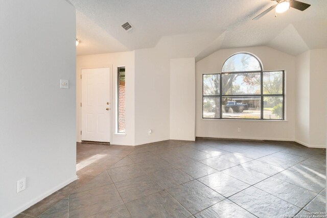 office space with tile patterned flooring, ceiling fan, and a textured ceiling