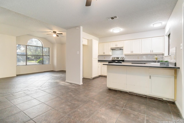 kitchen with dark countertops, visible vents, ceiling fan, and electric range