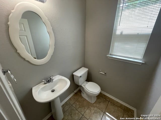 bathroom with tile patterned flooring and toilet