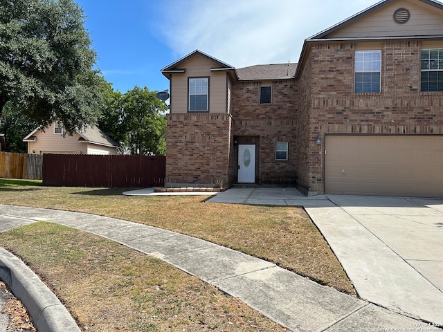 view of property featuring a front yard and a garage