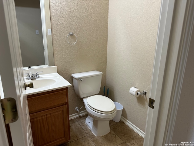 bathroom with tile patterned flooring, toilet, and vanity