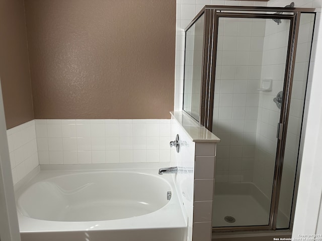 bathroom with separate shower and tub