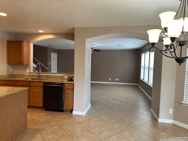 kitchen featuring dishwasher, a chandelier, stone counters, sink, and light tile patterned floors