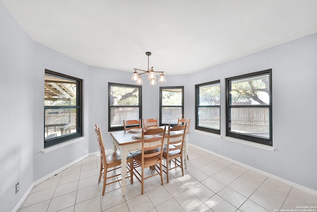 dining room featuring an inviting chandelier and light tile patterned flooring