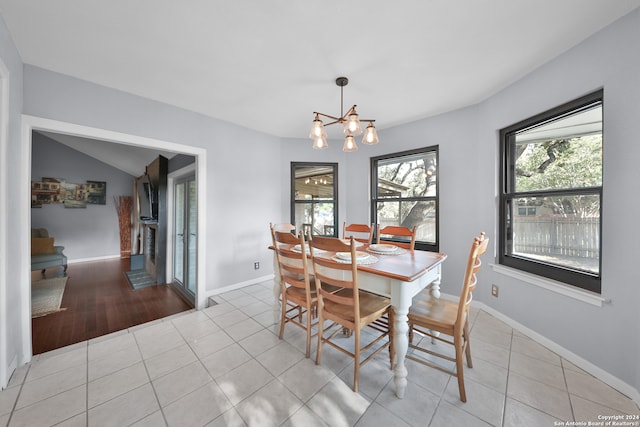 tiled dining space featuring a notable chandelier