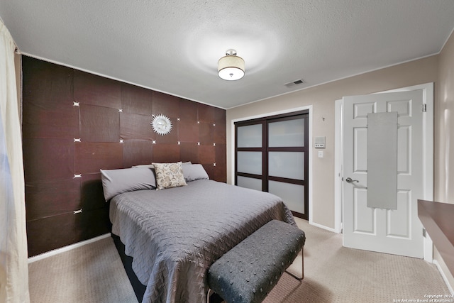 carpeted bedroom with a textured ceiling