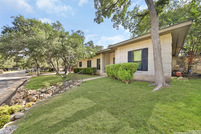 ranch-style home with a front lawn