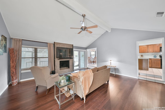 living room with vaulted ceiling with beams, a large fireplace, dark hardwood / wood-style floors, and ceiling fan