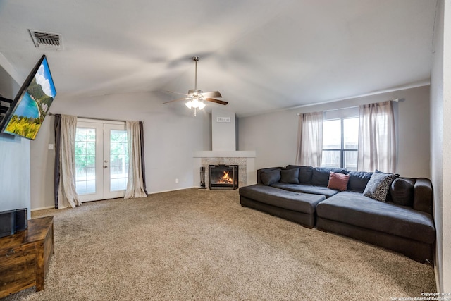 living room with a healthy amount of sunlight, ceiling fan, carpet flooring, and vaulted ceiling