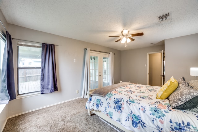 carpeted bedroom featuring a textured ceiling, ceiling fan, access to outside, and french doors