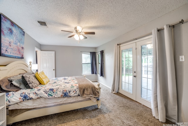 carpeted bedroom featuring a textured ceiling, ceiling fan, access to outside, and french doors