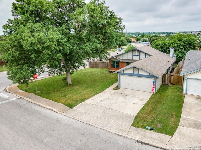 english style home with roof with shingles, concrete driveway, a front yard, and fence