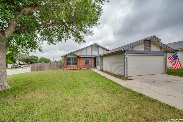 view of front of home with a garage, concrete driveway, a front yard, and fence