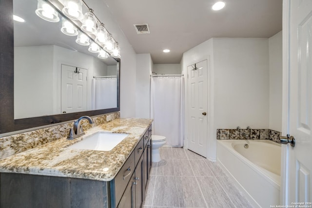 full bathroom featuring vanity, a bath, visible vents, tile patterned floors, and toilet