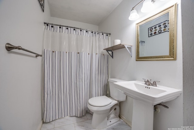 bathroom with a shower with shower curtain, toilet, and marble finish floor