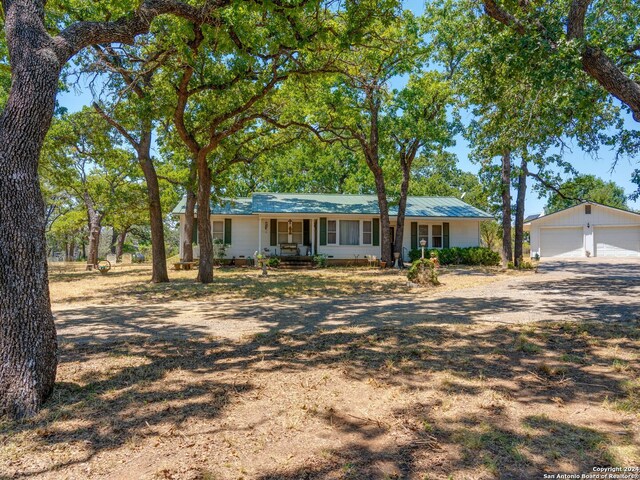 ranch-style house with an outdoor structure, a garage, and covered porch