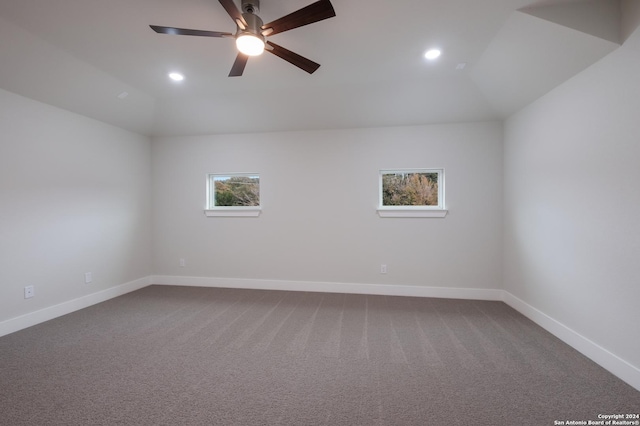 carpeted empty room featuring ceiling fan and vaulted ceiling