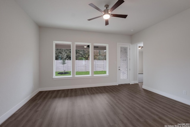 spare room featuring dark hardwood / wood-style floors and ceiling fan