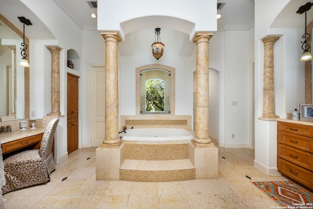 bathroom with tile patterned flooring, vanity, a relaxing tiled tub, and decorative columns