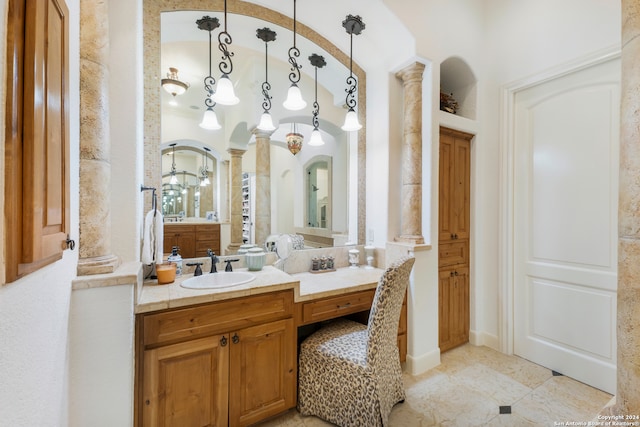 bathroom with vanity, ornate columns, and tile patterned flooring