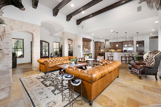 tiled living room featuring beam ceiling