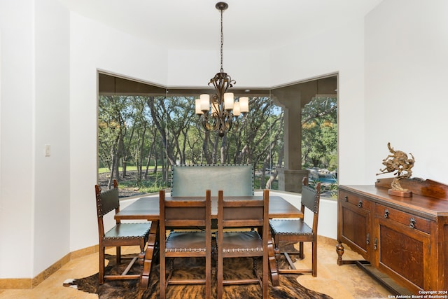 dining room with light tile patterned floors, a notable chandelier, and a healthy amount of sunlight