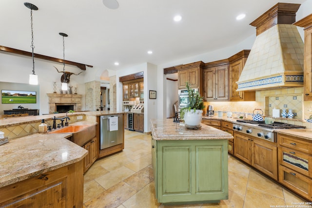 kitchen featuring a center island with sink, appliances with stainless steel finishes, tasteful backsplash, light stone counters, and light tile patterned flooring