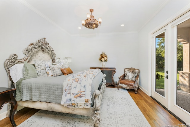 bedroom with ornamental molding, hardwood / wood-style flooring, access to outside, and a notable chandelier