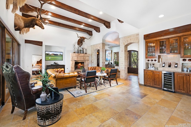 living room with light tile patterned floors, wine cooler, and beam ceiling