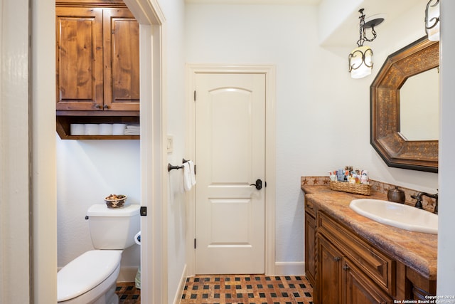 bathroom featuring vanity, toilet, and tile patterned floors