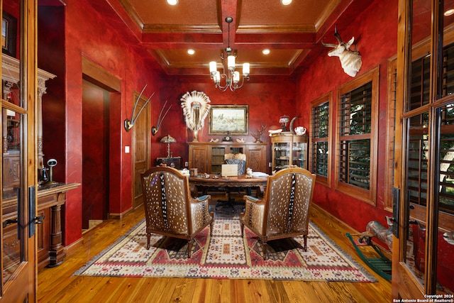 interior space with coffered ceiling, light hardwood / wood-style flooring, beam ceiling, and a notable chandelier