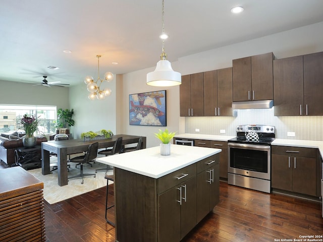 kitchen with stainless steel electric range oven, dark brown cabinetry, dark hardwood / wood-style flooring, and tasteful backsplash