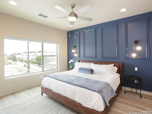 bedroom with light hardwood / wood-style flooring and ceiling fan