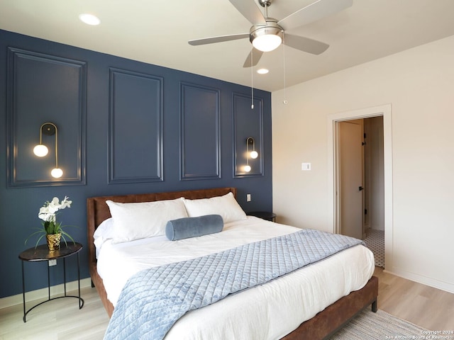 bedroom with light wood-type flooring and ceiling fan