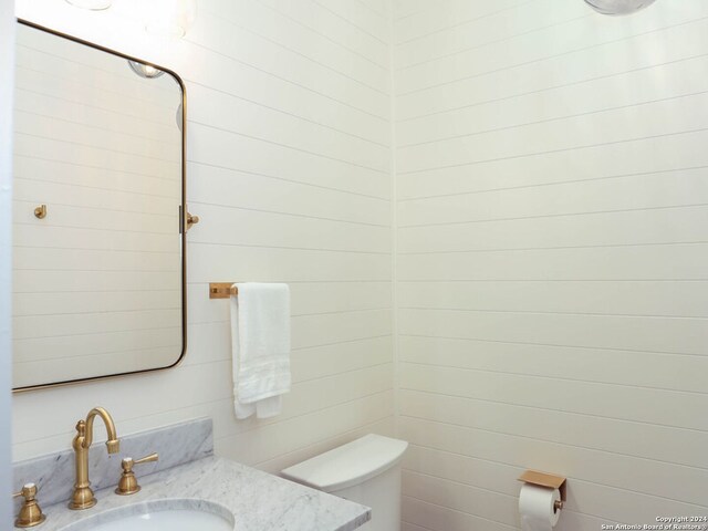 bathroom featuring vanity, a shower with shower door, ceiling fan, and hardwood / wood-style flooring