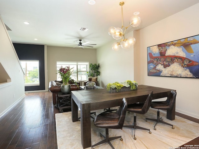 dining area featuring hardwood / wood-style floors and ceiling fan with notable chandelier