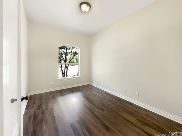 empty room featuring dark wood-type flooring