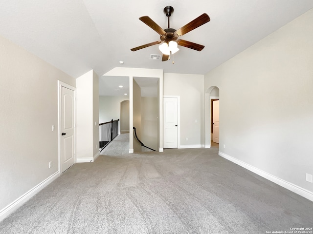 unfurnished bedroom with lofted ceiling, light colored carpet, and ceiling fan