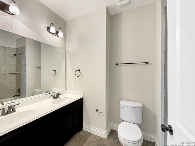 full bathroom featuring tile patterned flooring, vanity, toilet, and tiled shower / bath