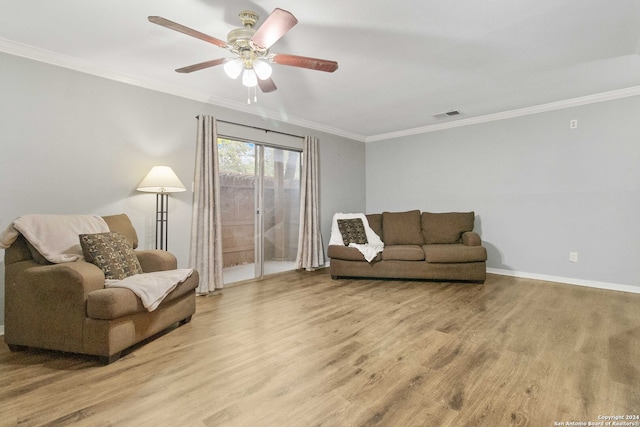 living area with light hardwood / wood-style floors, ornamental molding, and ceiling fan