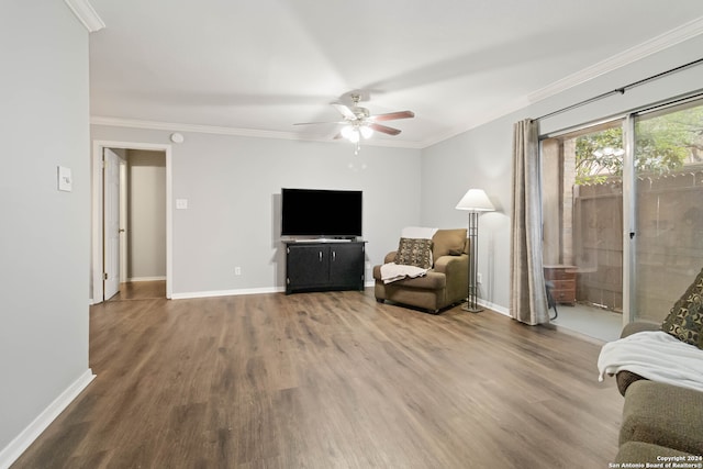 living room with ornamental molding, hardwood / wood-style floors, and ceiling fan