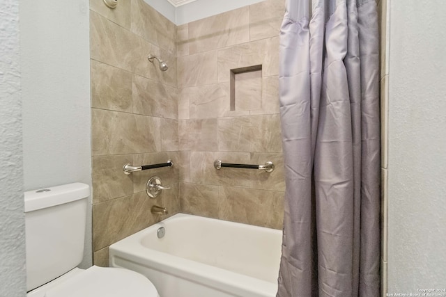 bathroom with toilet and shower / tub combo