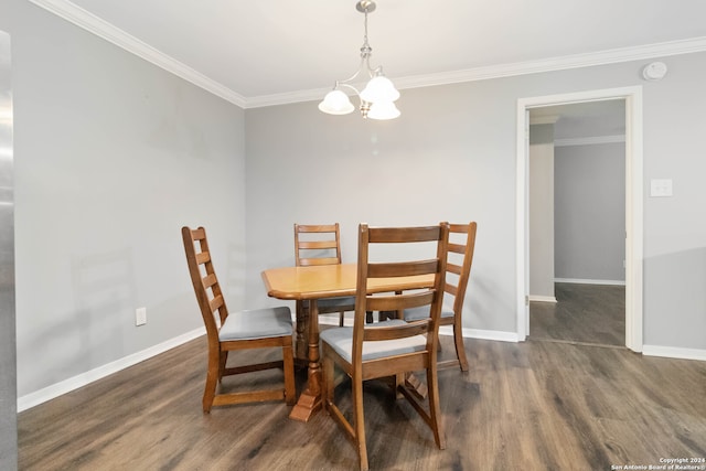 dining space featuring ornamental molding, a chandelier, and dark hardwood / wood-style flooring