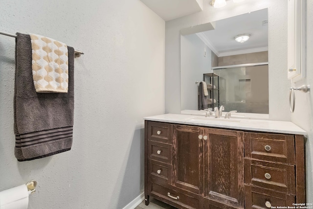 bathroom featuring vanity, toilet, ornamental molding, and a shower with shower door