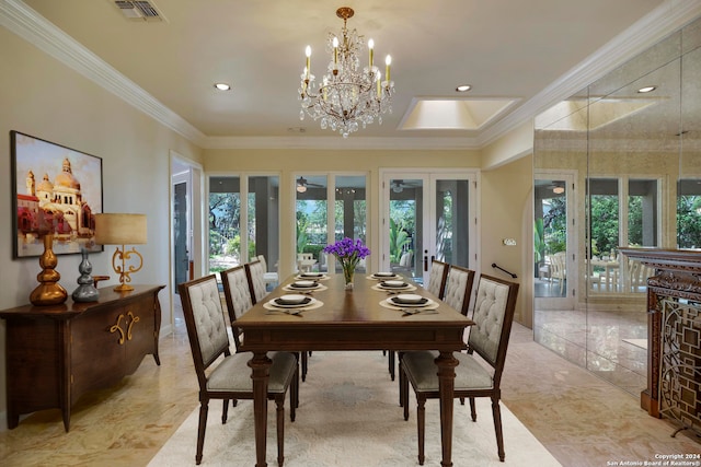 dining space with crown molding, french doors, and a notable chandelier