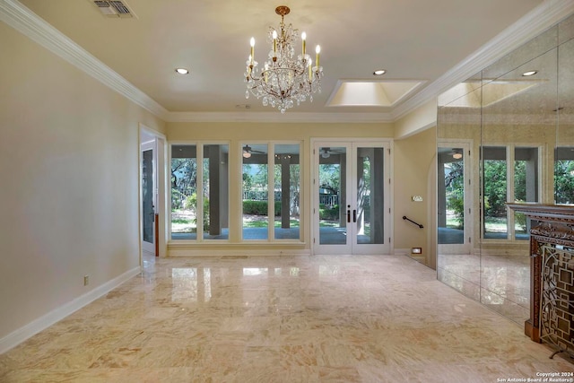 foyer entrance with french doors, ornamental molding, and a chandelier