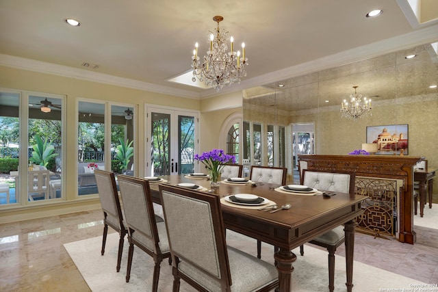 dining space with ceiling fan with notable chandelier, ornamental molding, and french doors